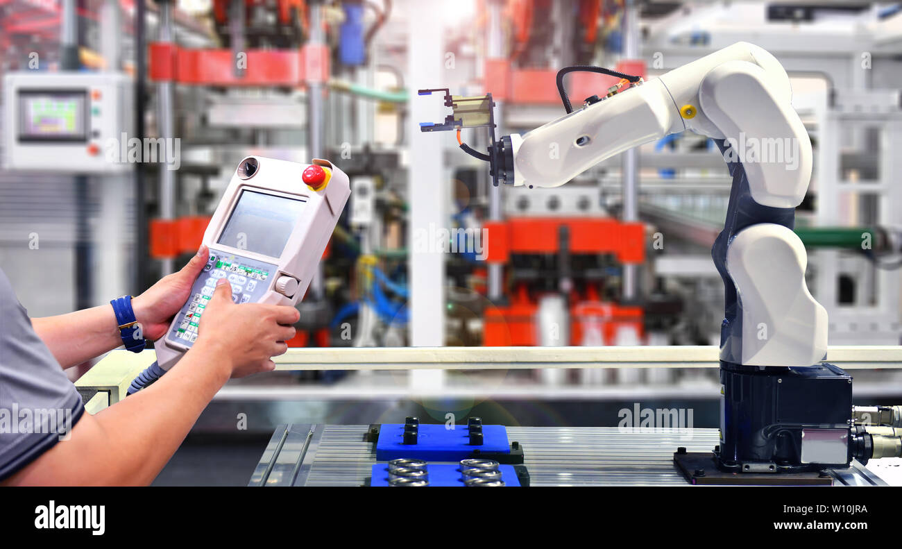 Engineer check and control automation Robot arm machine for Automotive bearings packing process in factory. Stock Photo