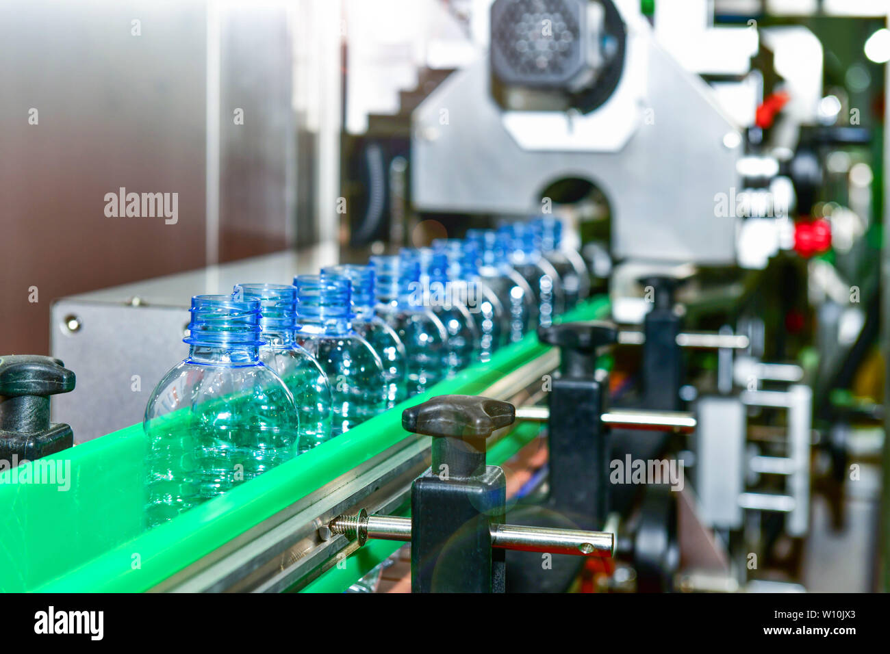Clear plastic Bottles transfer on Automated conveyor systems industrial automation for package Stock Photo