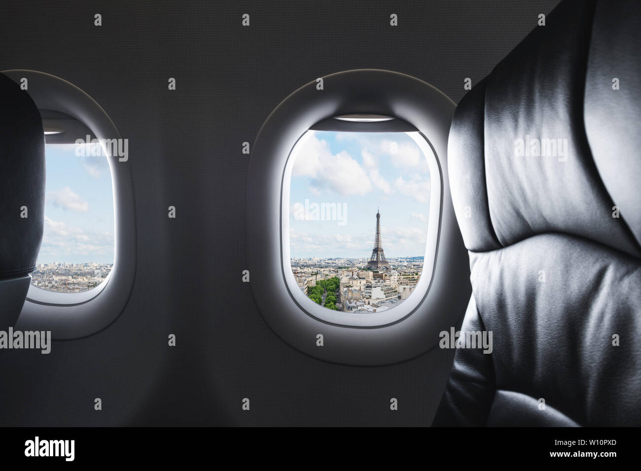 Traveling Paris, France famous landmark and travel destination in Europe. Aerial view Eiffel Tower through airplane window Stock Photo