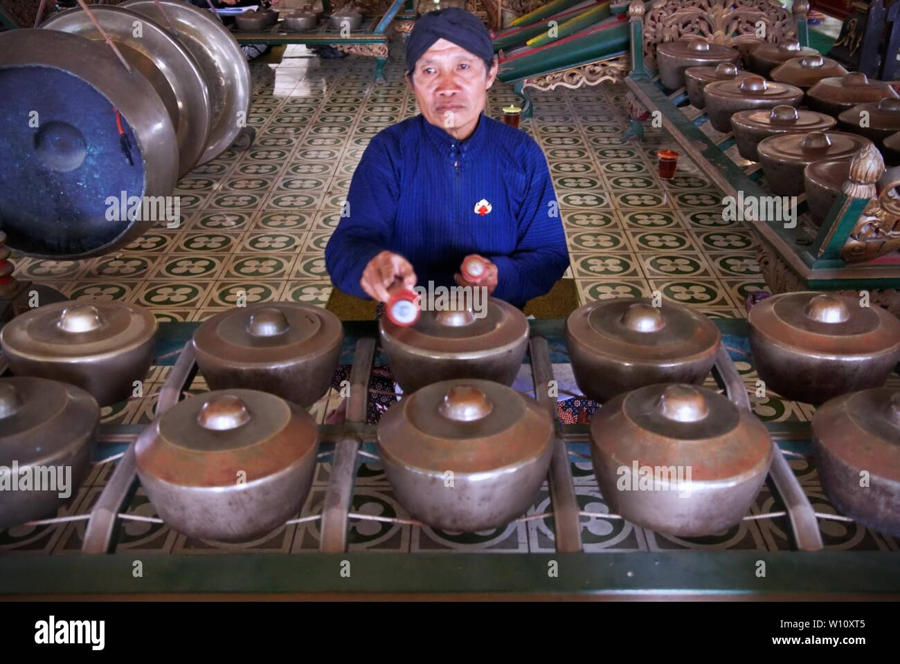 Gamelan player are playing their instrument in Yogyakarta Palace. Gamelan is traditional Javanese musical instrument. Stock Photo