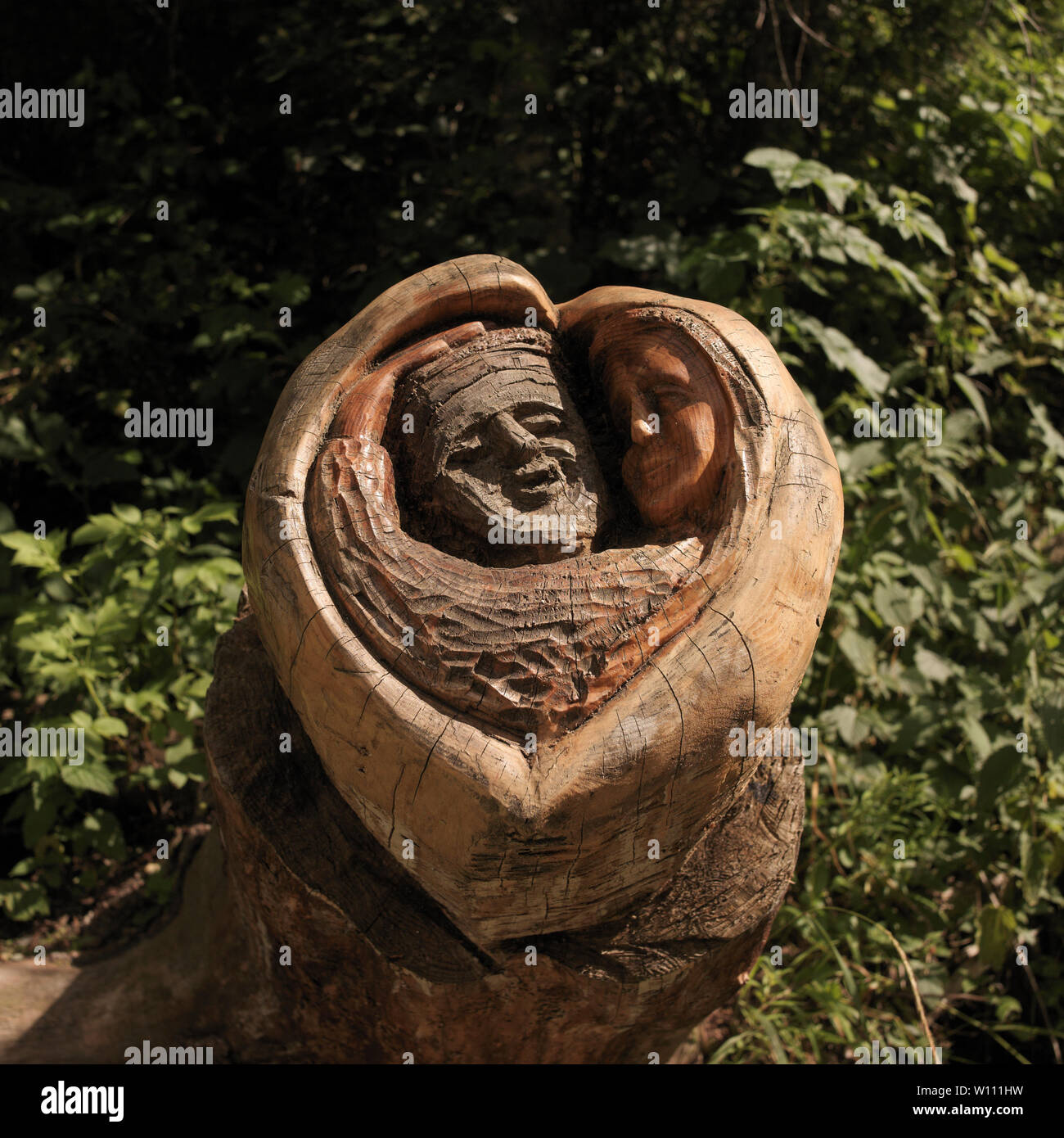 Ayas, Aosta Valley, Italy - August 10, 2006: Tree trunk carved along a mountain path. Stock Photo