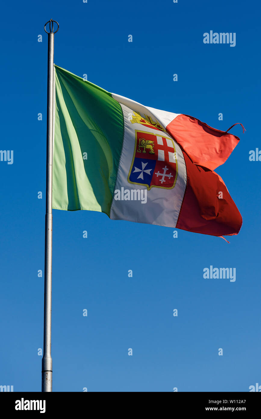 Italian nautical national flag with emblem of the four Maritime Republics, Venice, Genoa, Pisa and Amalfi on a clear blue sky Stock Photo