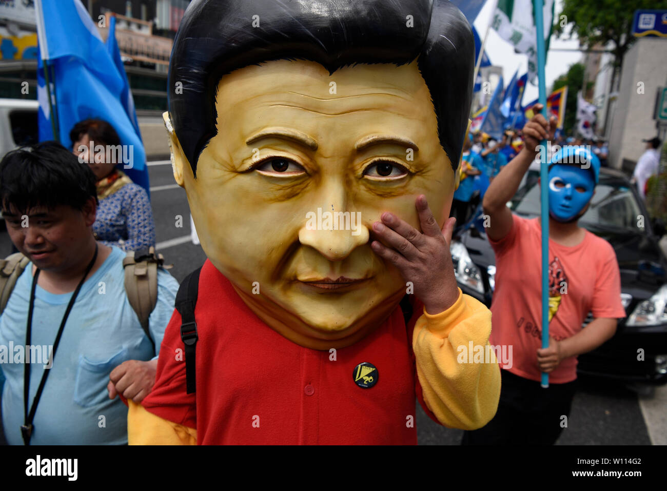 Osaka, Japan. 29th Jun 2019. A protestor wears a mask of Chinese President Xi Jinping at a demonstration during the G20 Summit in Osaka, Japan. Credit: Ben Weller/AFLO/Alamy Live News Stock Photo