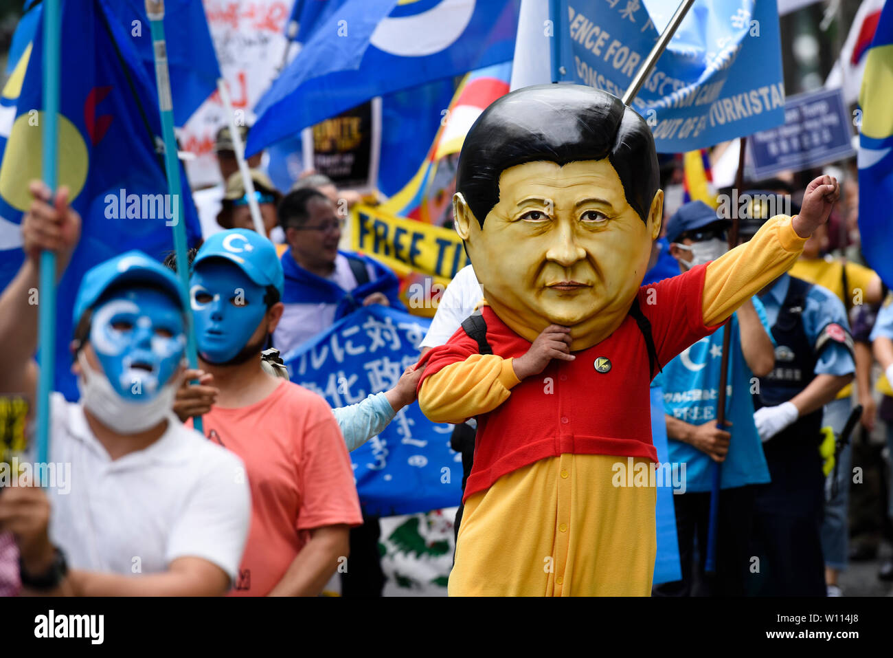 Osaka, Japan. 29th Jun 2019. A protestor wears a mask of Chinese President Xi Jinping at a demonstration during the G20 Summit in Osaka, Japan. Credit: Ben Weller/AFLO/Alamy Live News Stock Photo