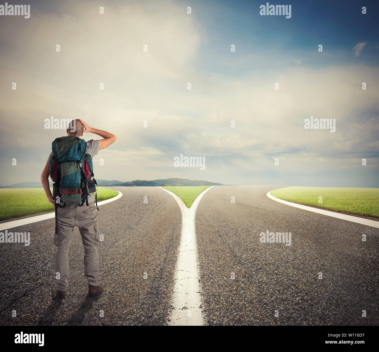 Businessman in front of a crossway must select the right way Stock Photo