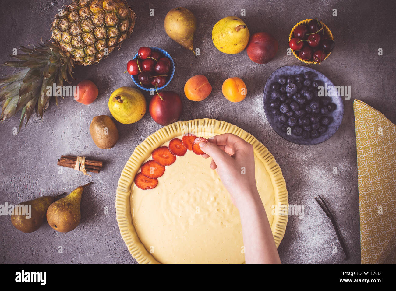 Female Hands Prepare Fruit Pie with Colorful Fruits and Fresh Dough. Healthy Food Concept. Stock Photo