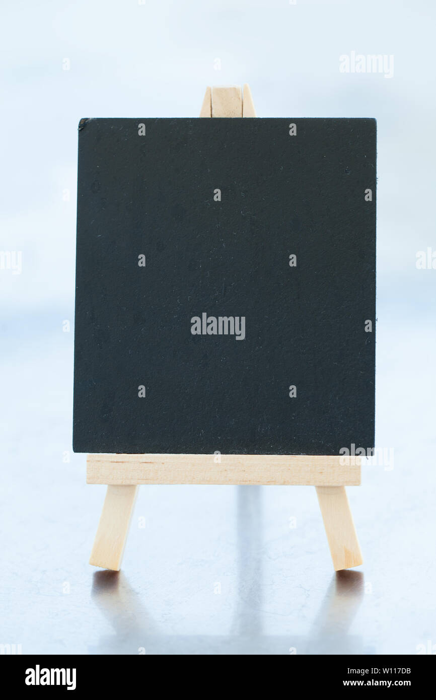 Blackboard for text and easel. Photo on white background with shadow
