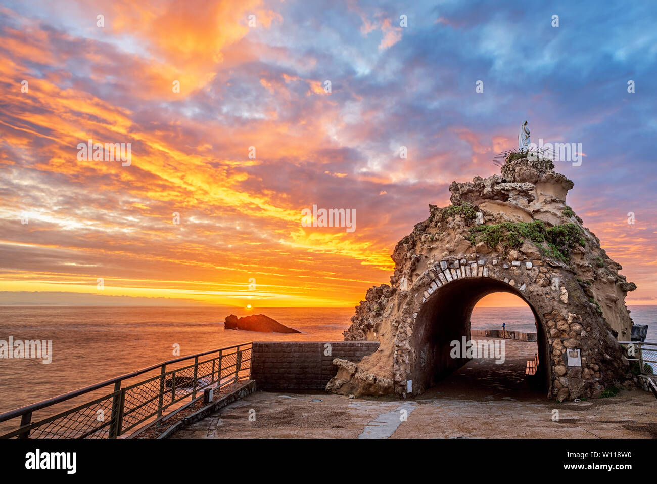 Biarritz, France, Rock of the Virgin (Rocher de la Vierge) on dramatical sunset over Atlantic ocean Stock Photo