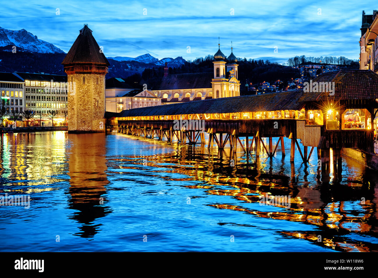 Lucerne, Switzerland, the Chapel bridge in the Old town reflecting in Reuss river in the late evening blue light Stock Photo