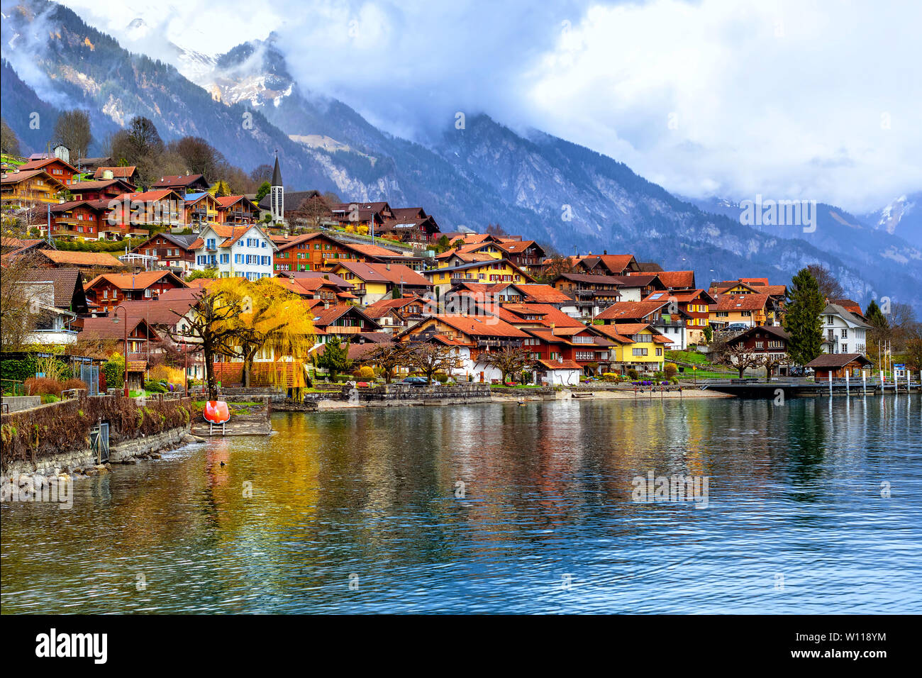 Old town of Oberried, Brienz, Interlaken and misty Alps mountains reflecting in lake, Switzerland Stock Photo