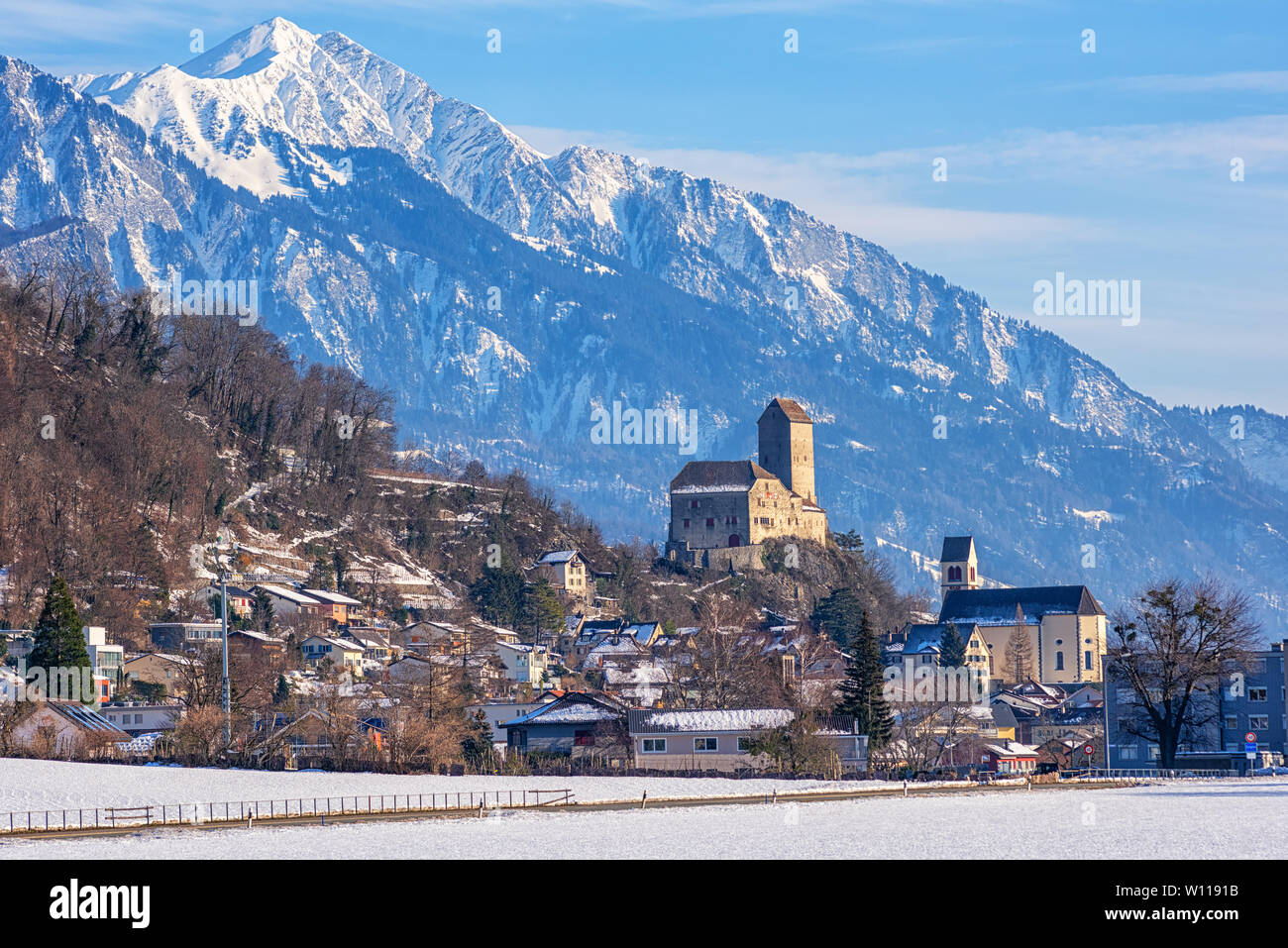 Sargans town with its famous medieval castle and snow Alps mountains peaks in background, St Gallen canton, Switzerland Stock Photo