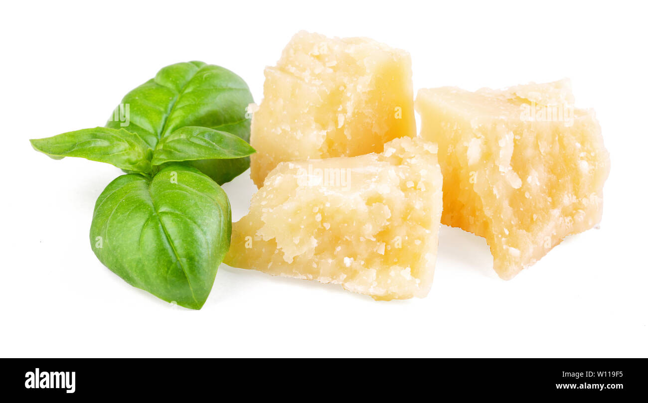 Three slices of permesan reggiano and basil bush isolated on white background, macro shooting, front view Stock Photo