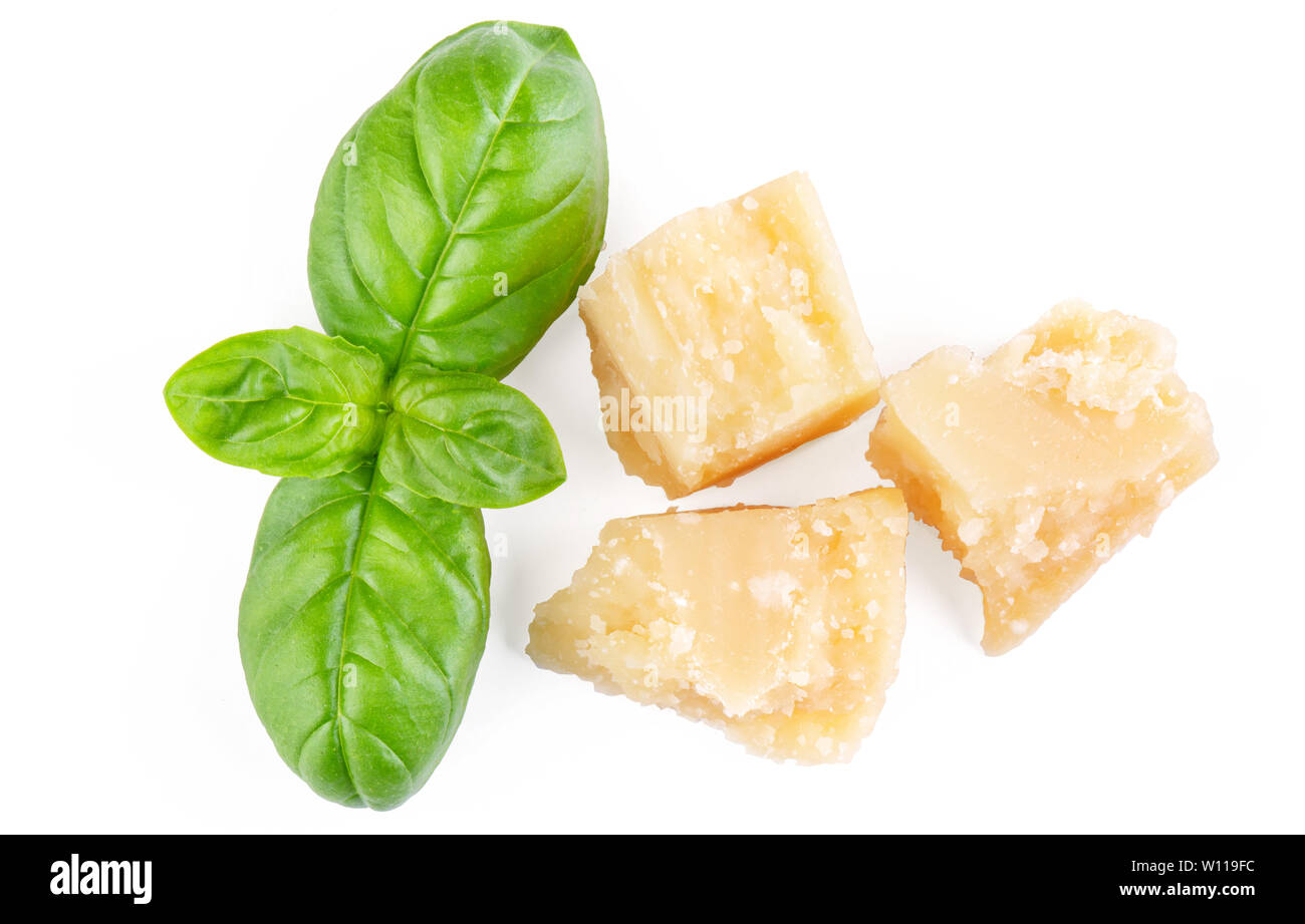 Three slices of permesan reggiano and basil bush isolated on white background, macro shooting, top view Stock Photo