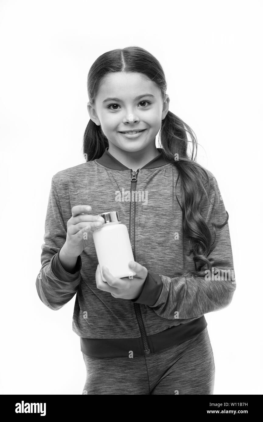 Vitamin supplements concept. Girl long hair hold plastic bottle with medicines copy space. Add vitamin to your ration. Need vitamin supplements. Most important vitamins and minerals every kid need. Stock Photo