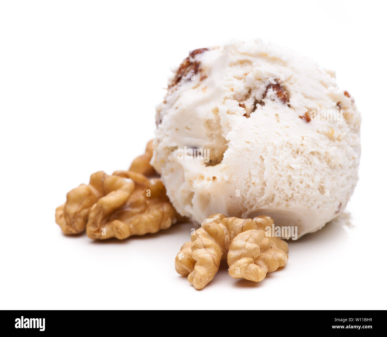 A scoop of walnut ice cream decorated with walnuts. Real edible ice