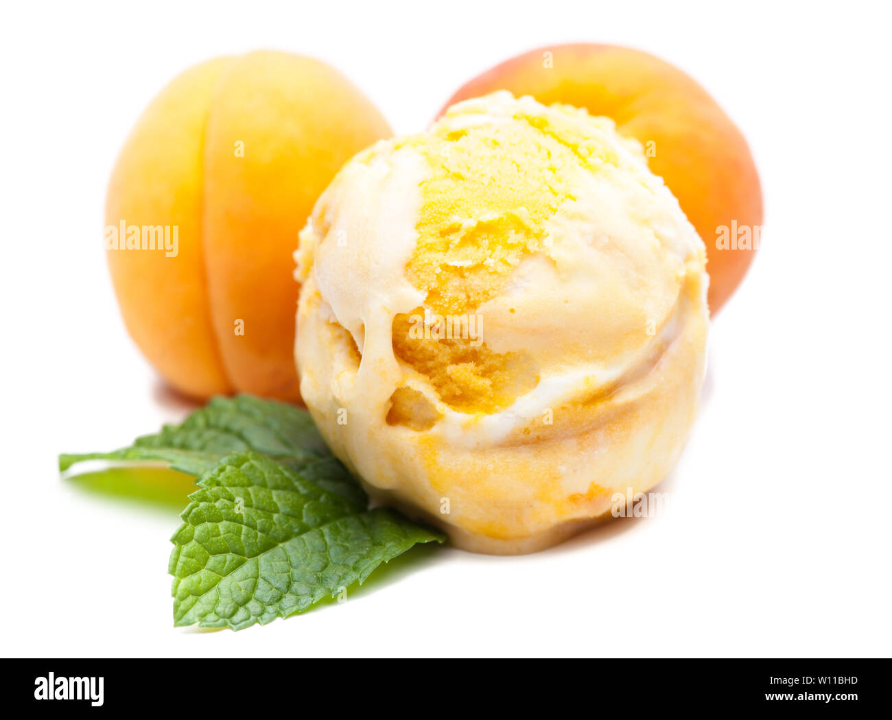 A scoop of apricot ice cream with mint and real apricots. Real edible ice cream - no artificial ingredients used Stock Photo