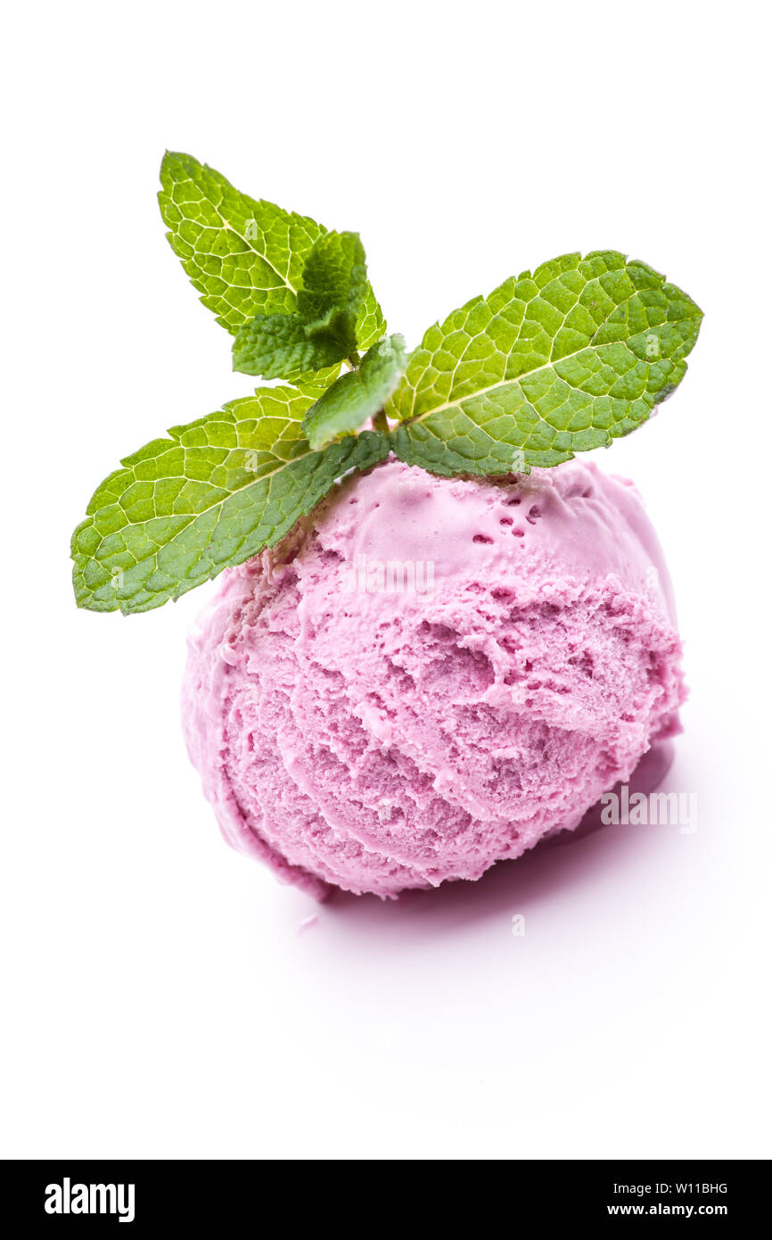 A scoop of wild berry ice cream topped with mint leaves. Real edible