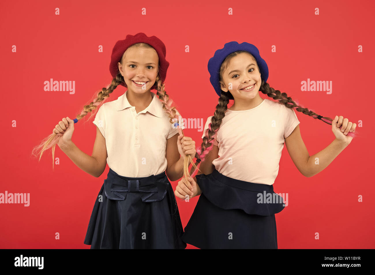 Schoolgirls french little kids smiling face posing hat red background. How to wear french beret