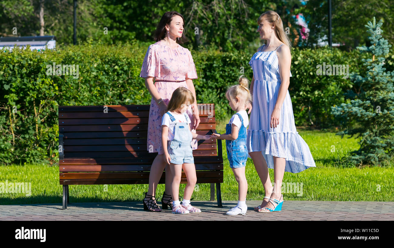 Women Friends 35 40 Years Age And Small Daughters 4 5 Years Of Age Are Talking In The Park Stock Photo Alamy Women Friends 35 40 Years Age And Small Daughters 4 5 Years Of Age Are Talking In The Park Stock Photo Alamy