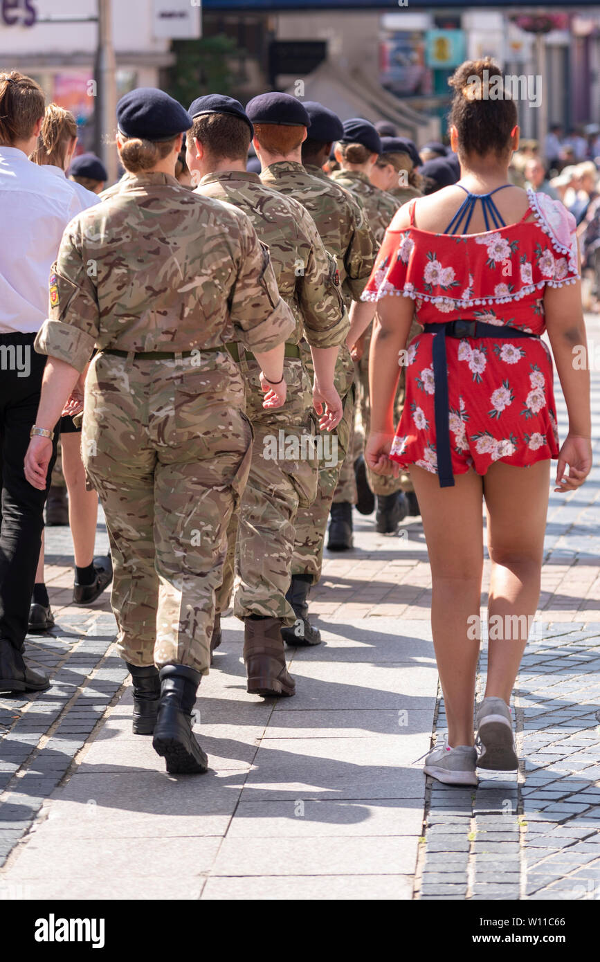 A parade  took place in Southend's High Street for Armed Forces Day, with young army cadets being joined by a female in summer clothes Stock Photo