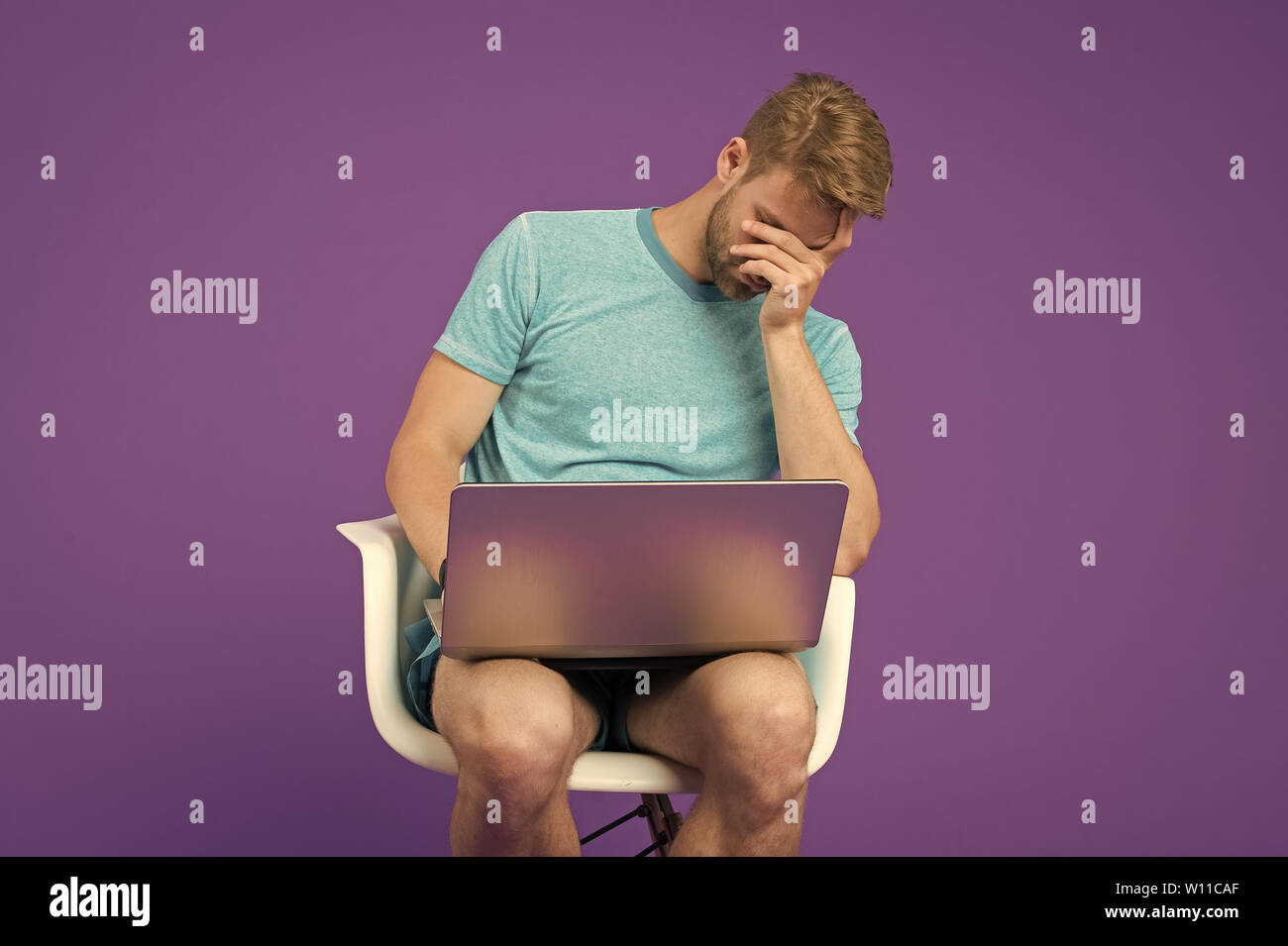 Feeling Sick And Tired Frustrated Young Man Covering Face With Hands While Sitting With Laptop 