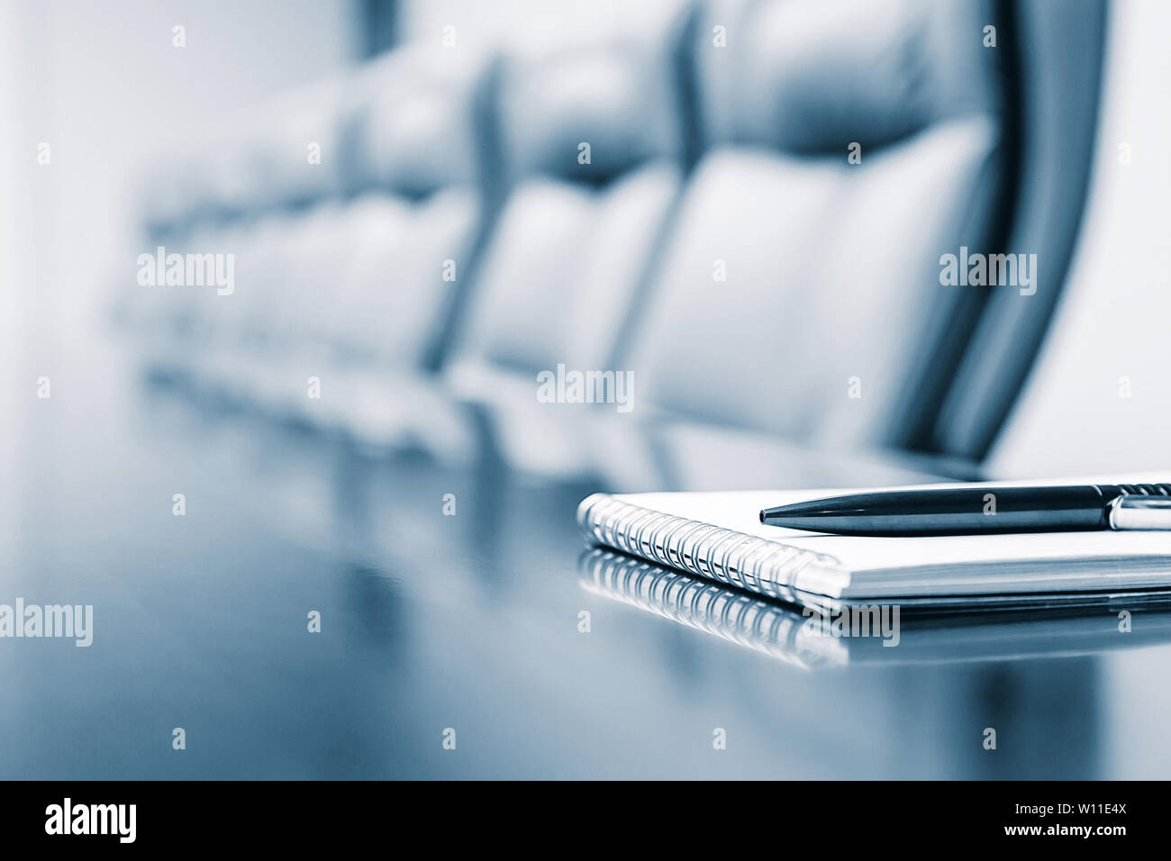 Closeup of notepad kept on table in empty room Stock Photo