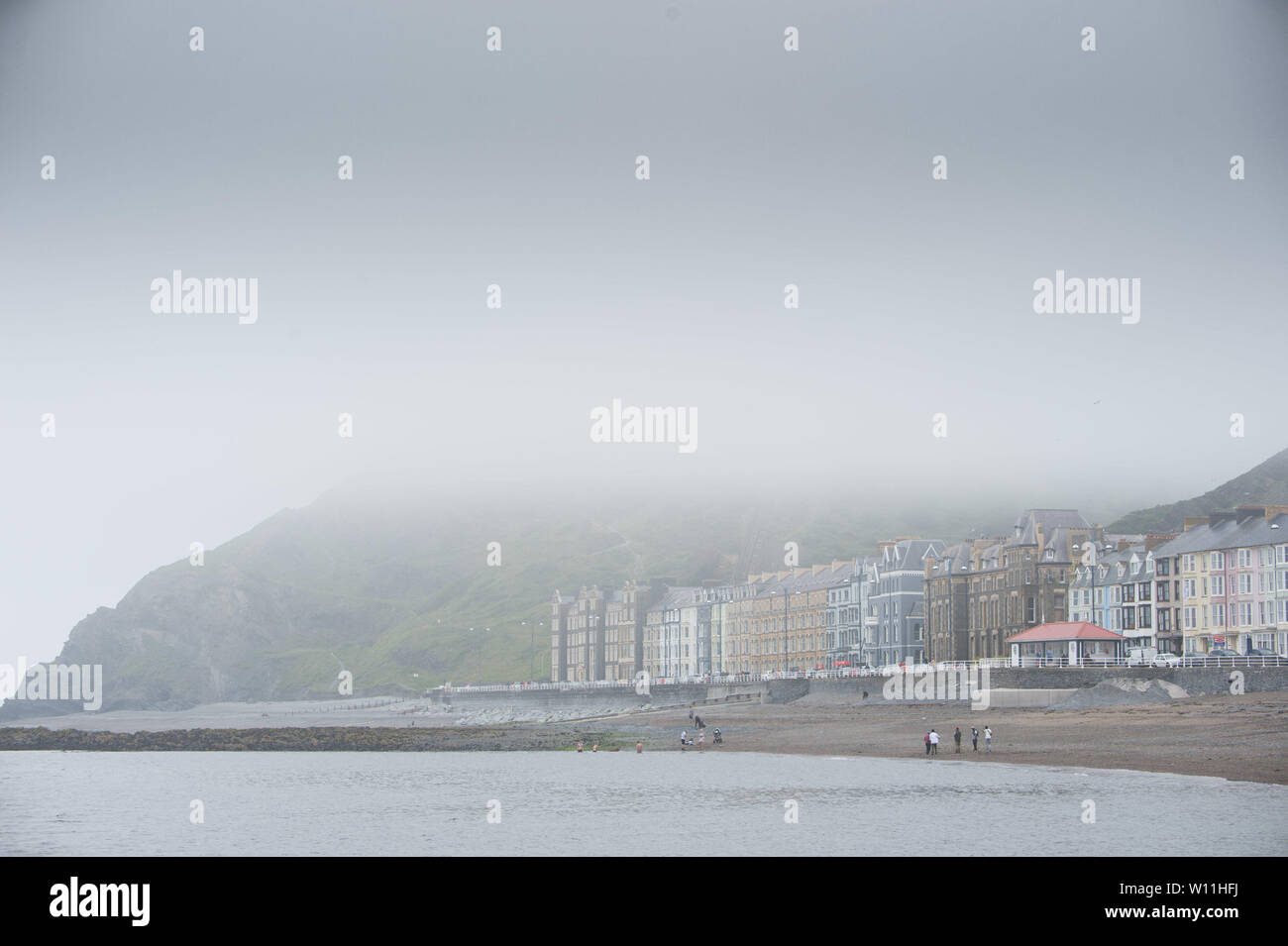 Aberystwyth, Wales, UK. Saturday 29 Jun 2019.  UK weather: As the south east of England is experiencing record breaking hot weather, Aberystwyth on the west coast of Wales is shrouded in low cloud and sea mist, keeping the temperatures substantially cooler.   Photo credit Keith Morris / Alamy Live News Stock Photo