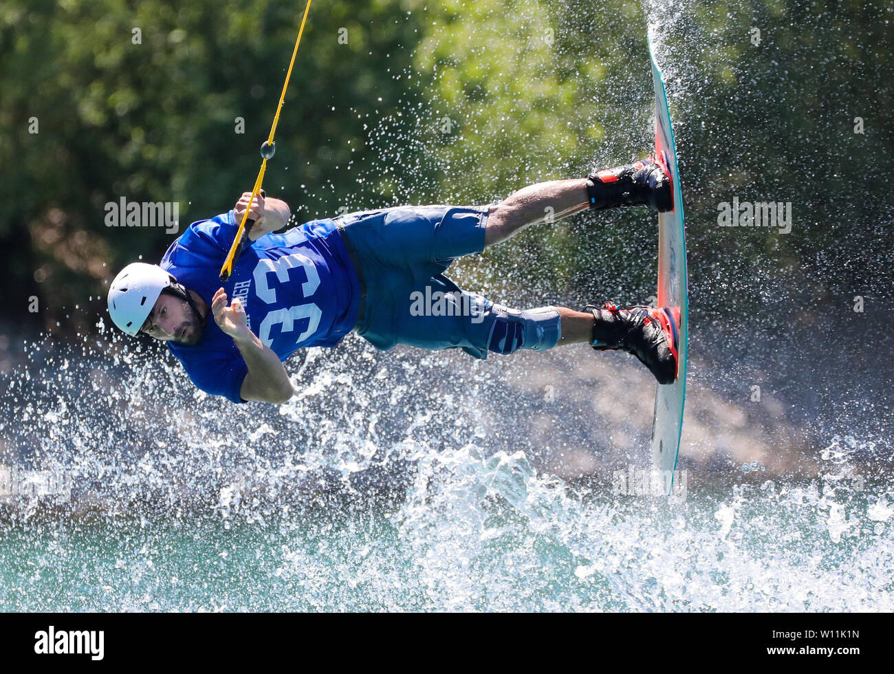 29 June 2019, Baden-Wuerttemberg, Mengen: Dave Tomasulo is on a wakeboard in the water ski park. Photo: Thomas Warnack/dpa Stock Photo