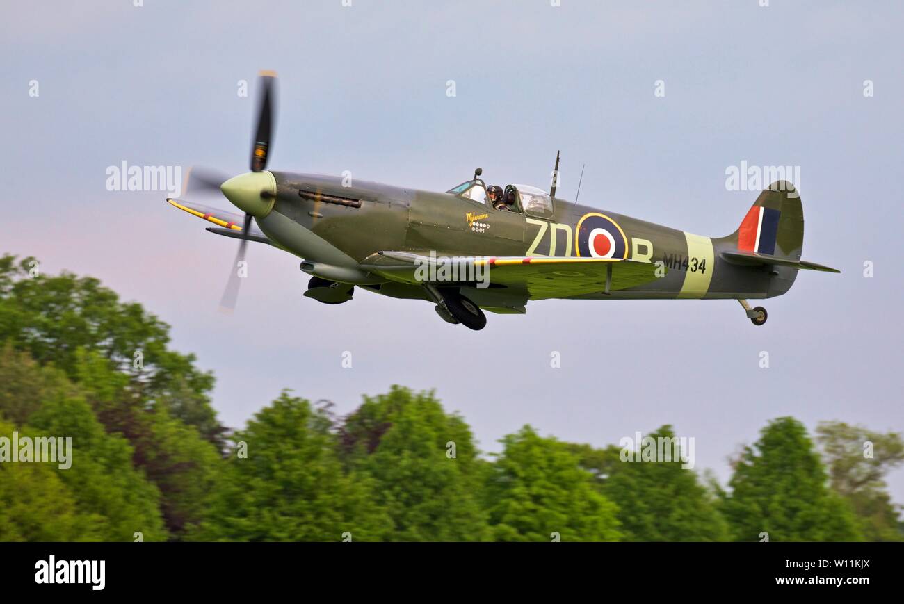 Spitfire LF Mk IX, MH434 'Mylcraine' airborne at Shuttleworth evening airshow on the 18th May 2019 Stock Photo