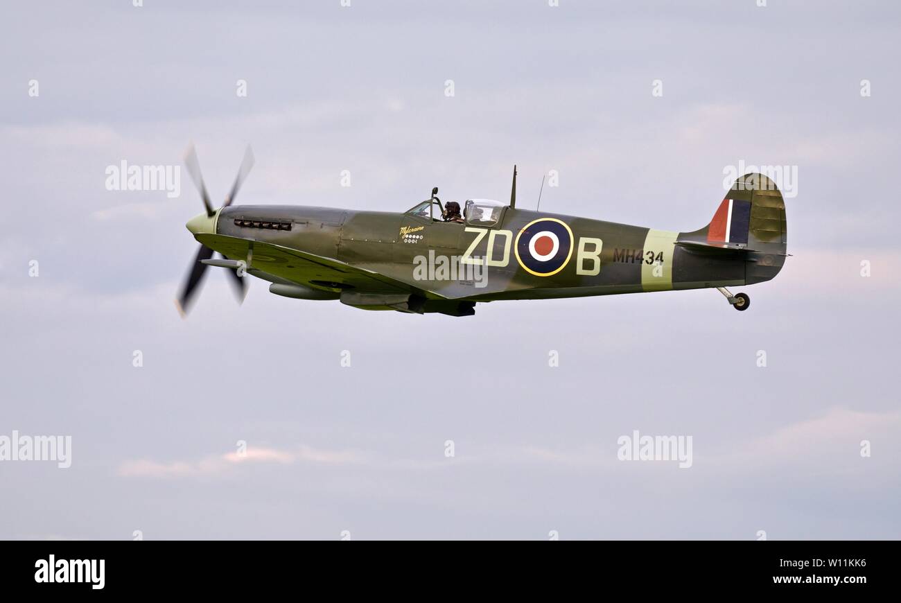 Spitfire LF Mk IX, MH434 'Mylcraine' airborne at Shuttleworth evening airshow on the 18th May 2019 Stock Photo