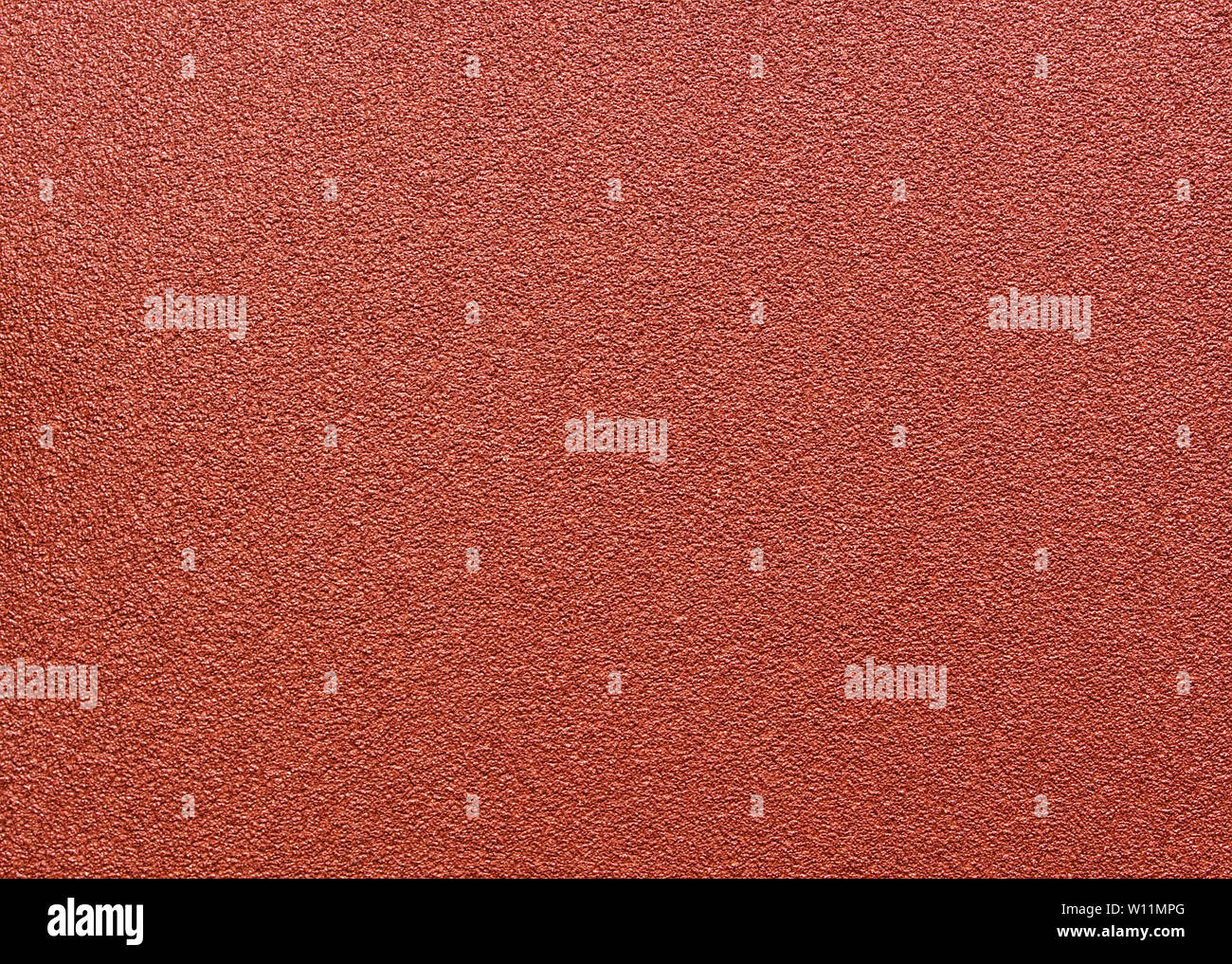 Red abrasive sandpaper seamless grunge surface, close up macro Stock