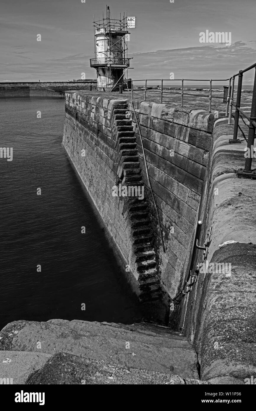 Black and white image of the light house on whitehaven harbour Stock Photo