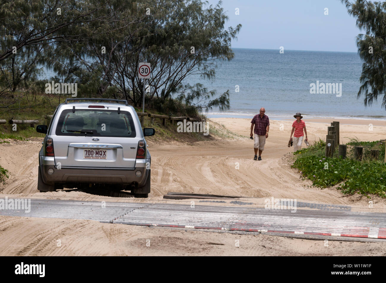A 4x4 makes its way onto the 75 mile long beach at Eurong Beach Resort on Fraser Island off the coast of Queensland, Australia Stock Photo