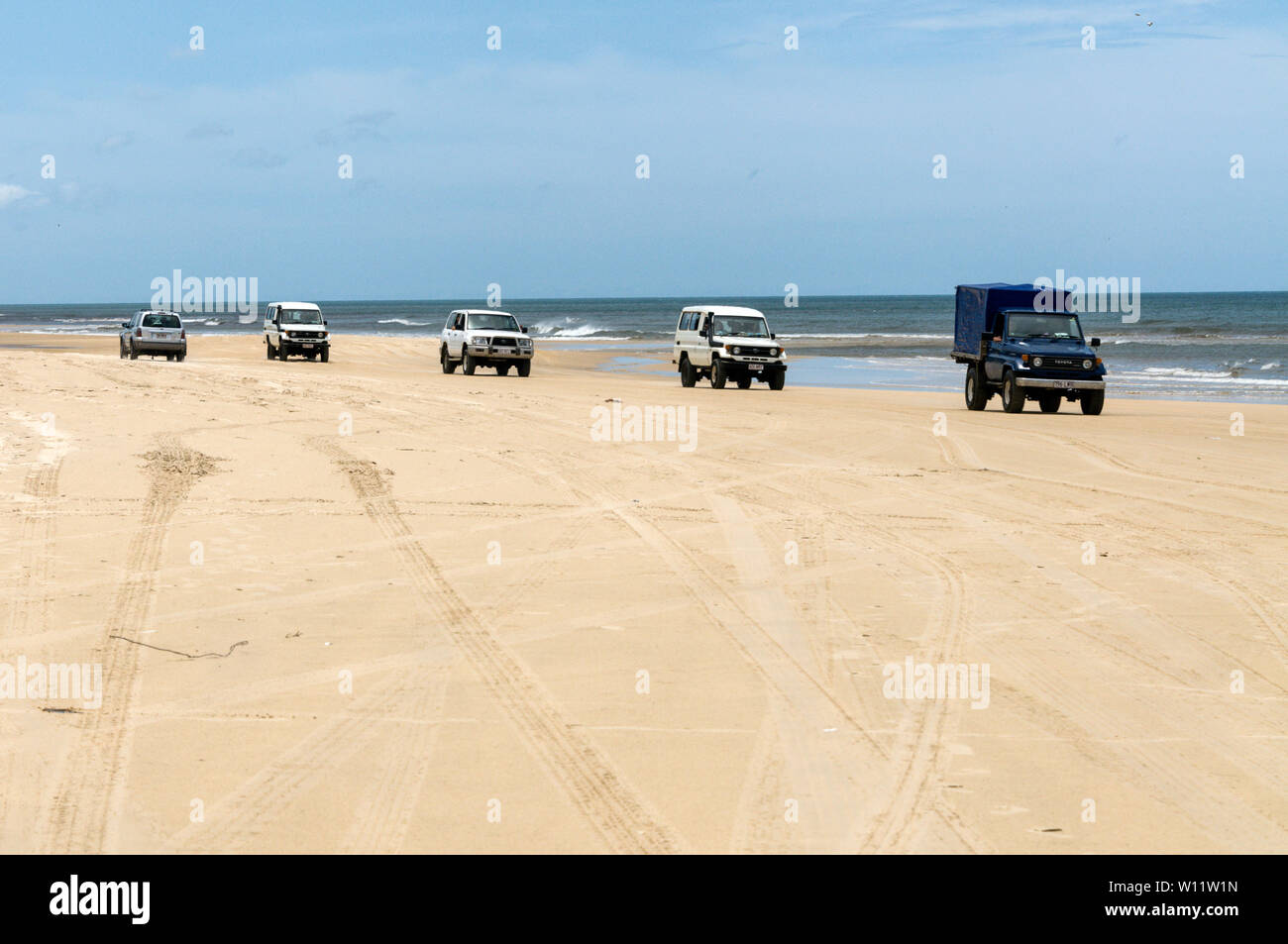 A convoy of 4x4s on the 75 mile long Sandy Highway on Fraser Island, Queensland,Australia Stock Photo