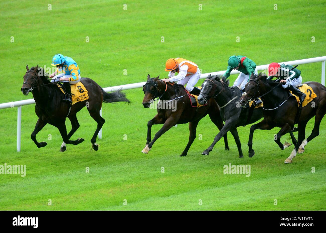 Insignia Of Rank and Gary Carroll (orange colours) get up to win the Dubai Duty Free Celebration Stakes during day two of the Dubai Duty Free Irish Derby Festival at Curragh Racecourse, County Kildare. Stock Photo