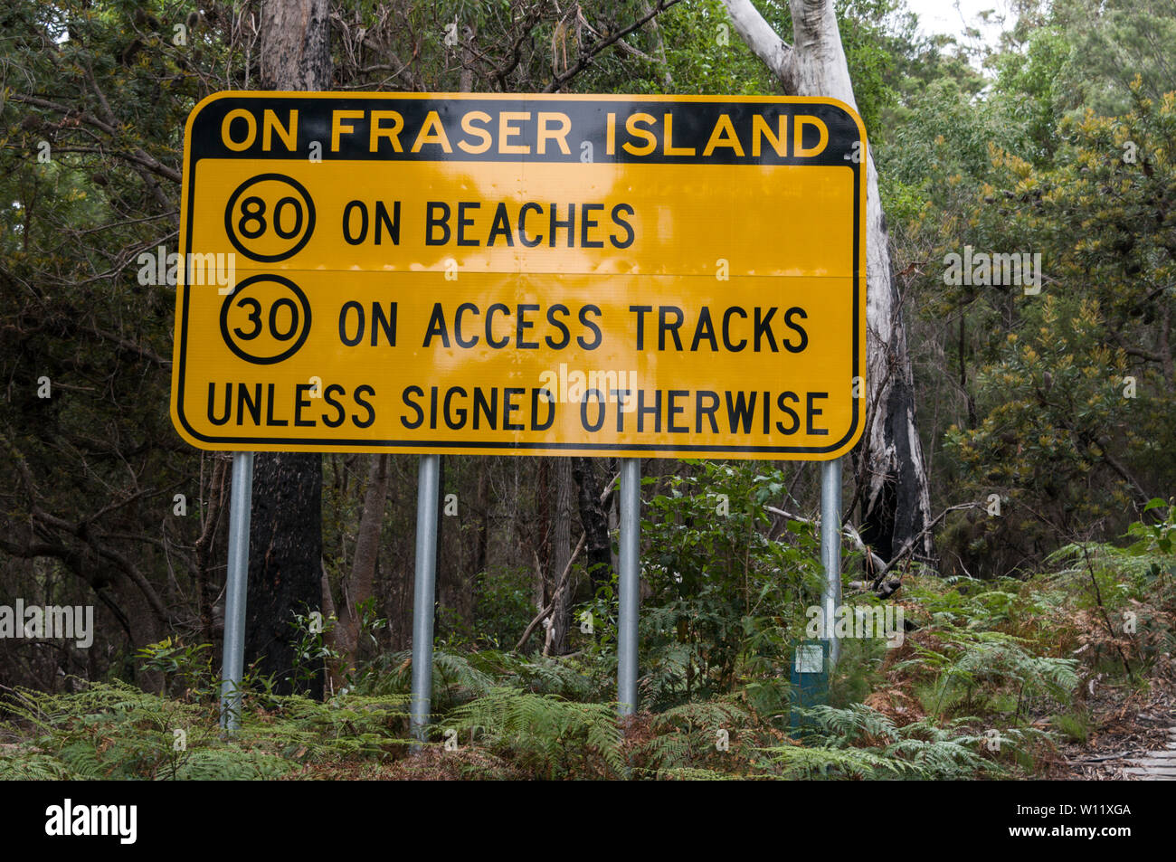 A road sign advising on speed limits at the beginning  of the rough track leading into the rain forest at  Kingfisher Bay resort on Fraser Island, Que Stock Photo