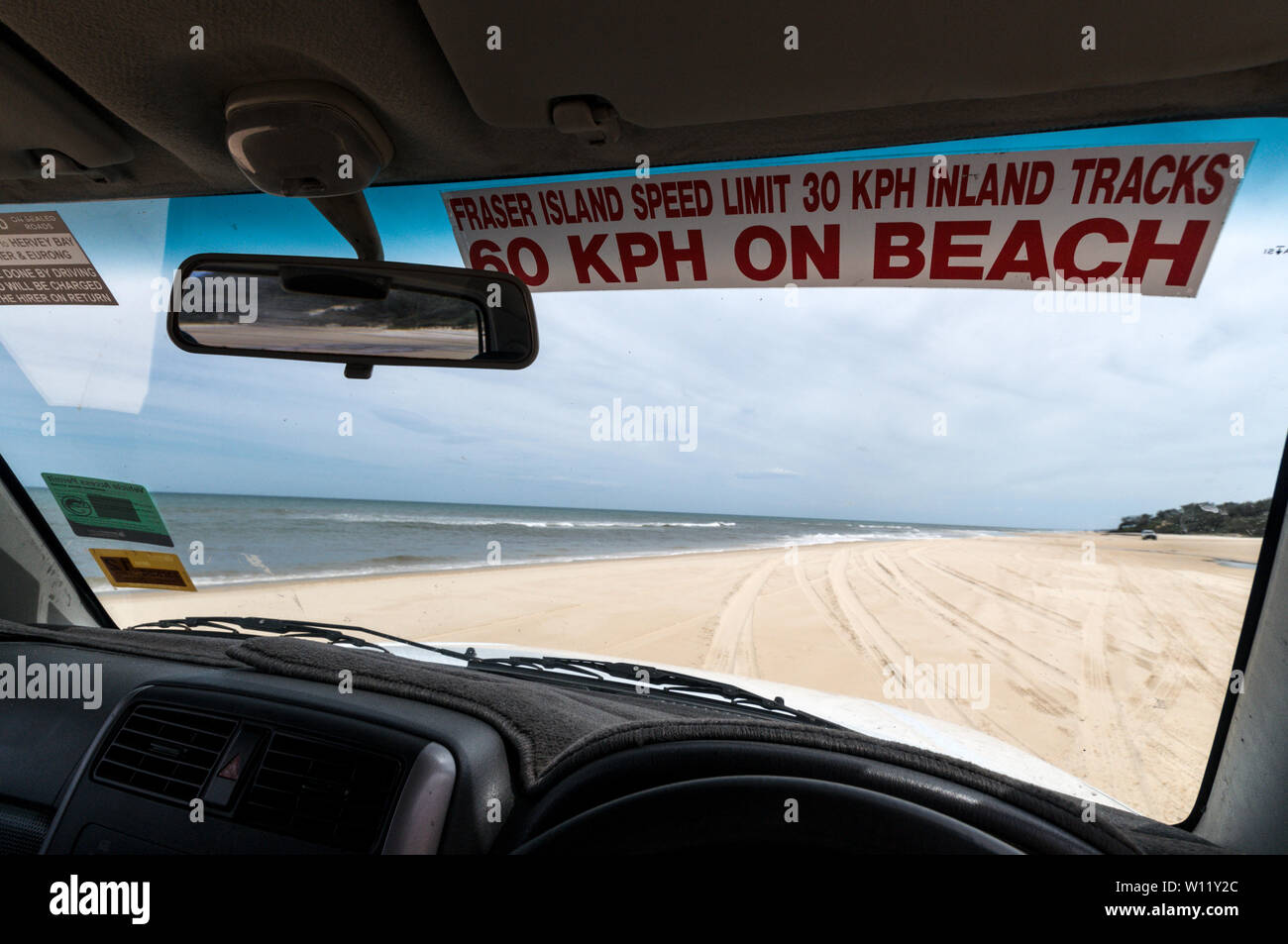 A reminder sticker attached to the driver's side of the windscreen of the speed limit allowed on the 75 mile sandy Highway on Fraser Island in Queensl Stock Photo