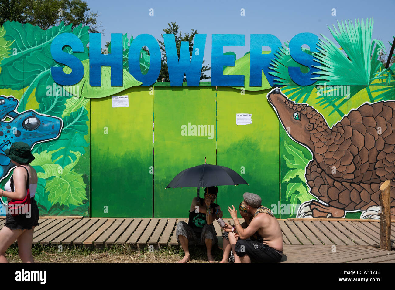 The Greenpeace showers shut to let reservoirs refill at Glastonbury  Festival at Worthy Farm in Pilton, Somerset Stock Photo - Alamy