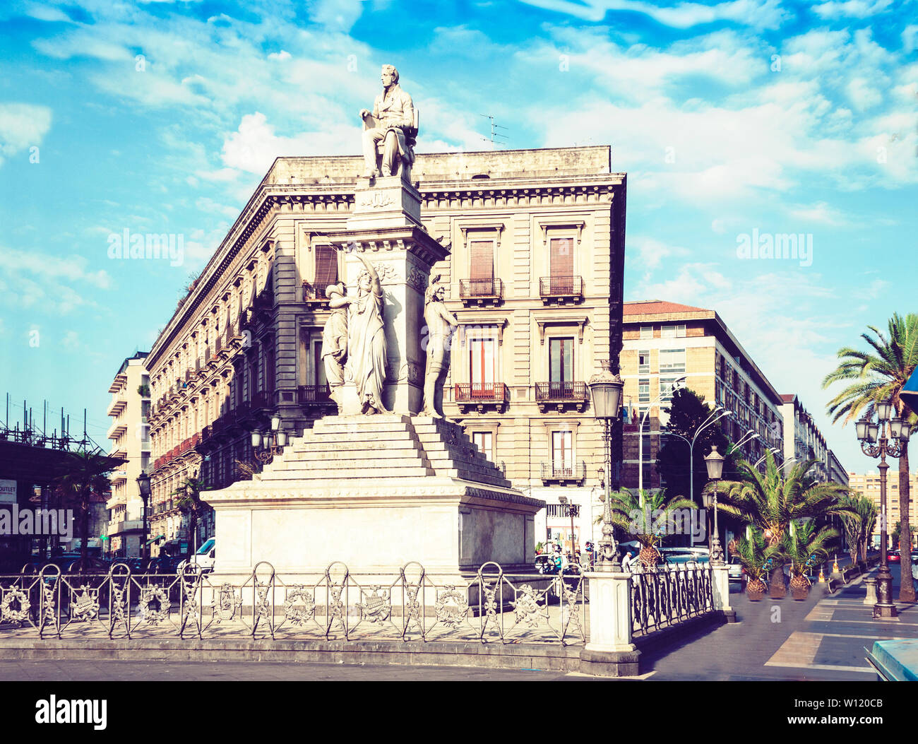 Traditional architecture of Sicily in Italy, typical street of Catania, facade of old buildings with monument of Vincenzo Bellini Stock Photo