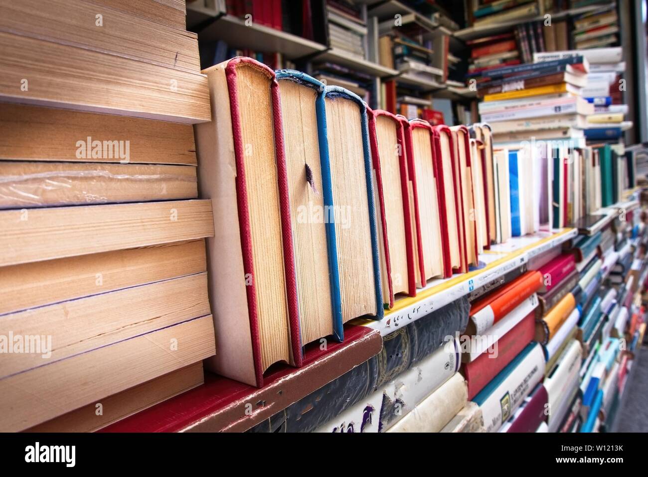 Piles of old books on a stall. Stock Photo