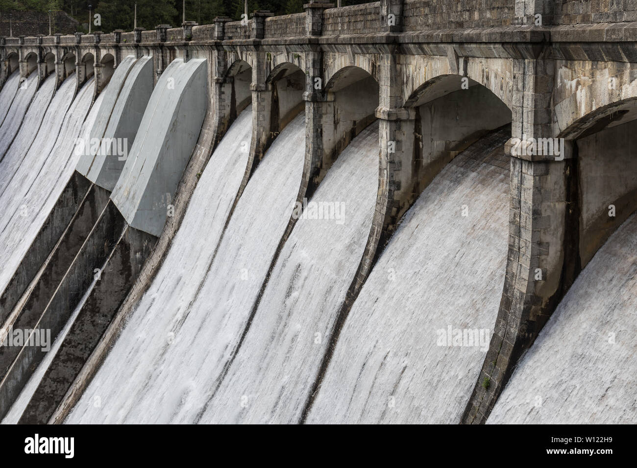 Water rushing through gates at a dam - Santa Caterina Lake, Auronzo di Cadore, Veneto, Italy Stock Photo