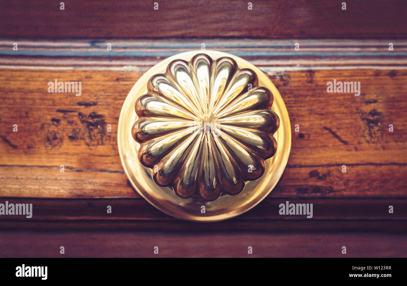Exterior Vintage Door Handle With A Bronze Finish On A Wooden