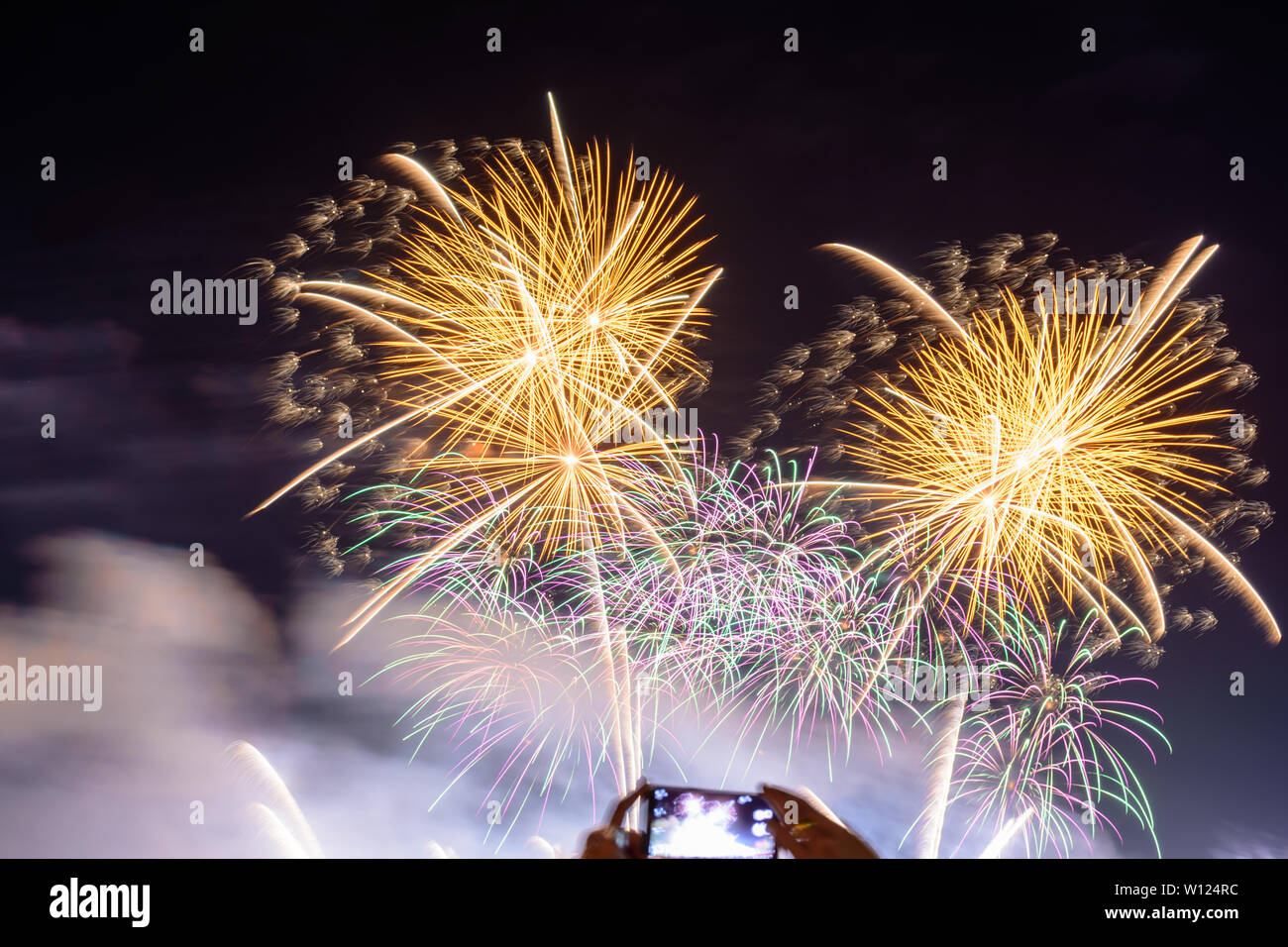 Colored firework background with free space for text. Colorful fireworks at night light up the sky with dazzling display. Stock Photo