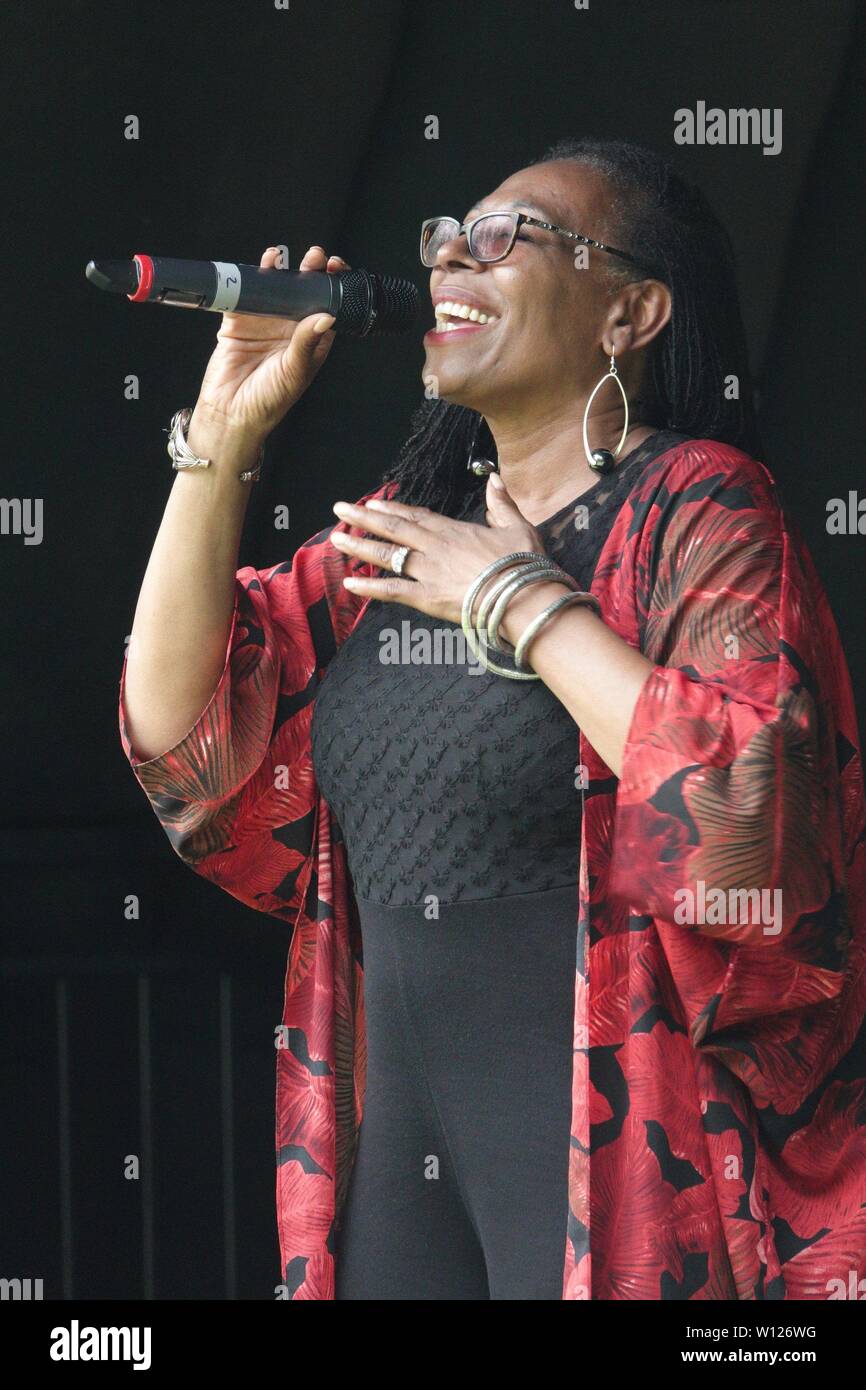 Liverpool, UK. 29th June, 2019. Carroll Thompson on stage at Liverpool's Windrush generation, a community family fun day event in Faulkner Square Park, Toxteth, Liverpool. Credit: ken biggs/Alamy Live News Stock Photo