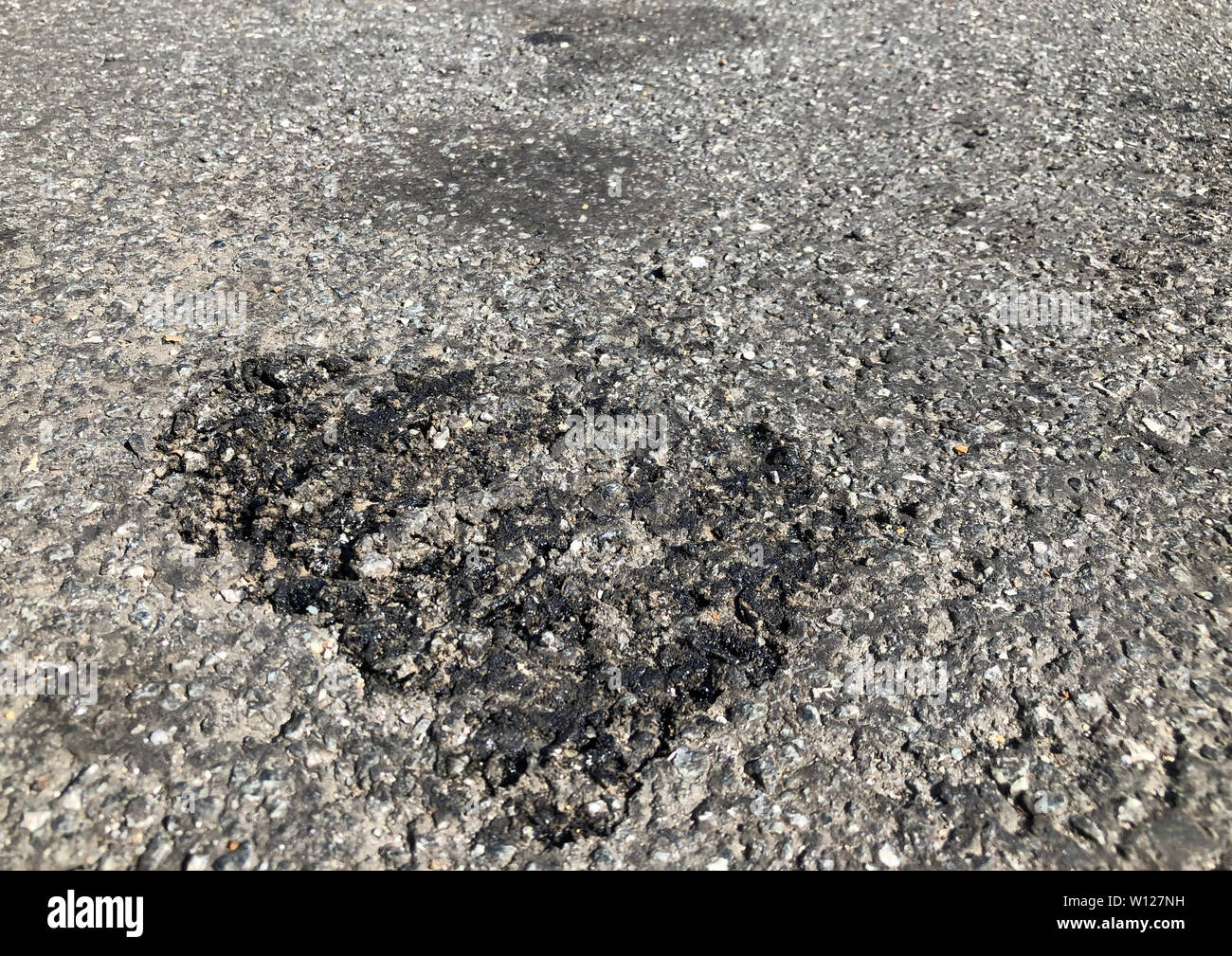 Melted tarmac in Bracknell, Berkshire as a new record temperature has been set for 2019, with the mercury expected to keep rising. Stock Photo