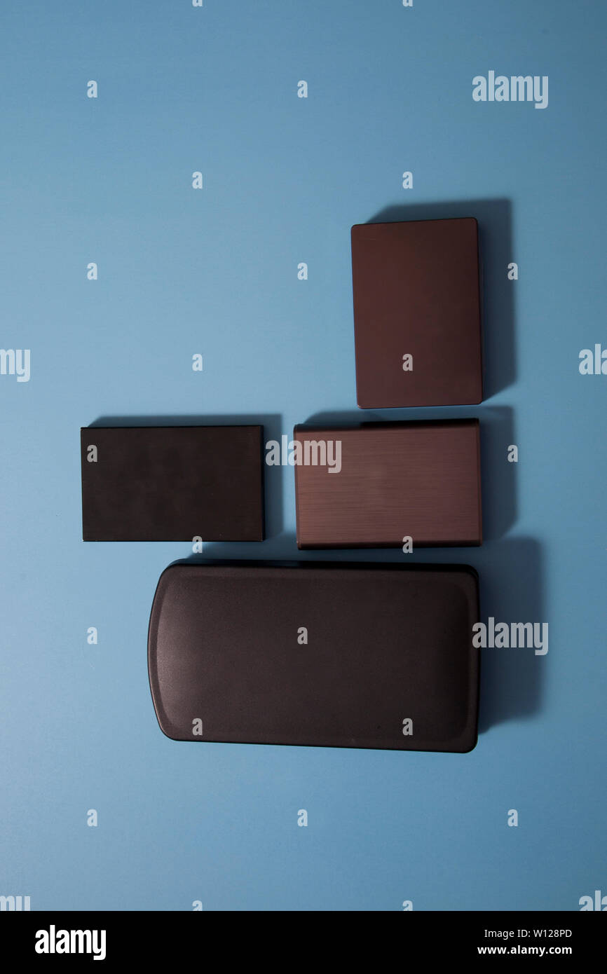 different grey and black external computer hard drives or back up storage Stock Photo