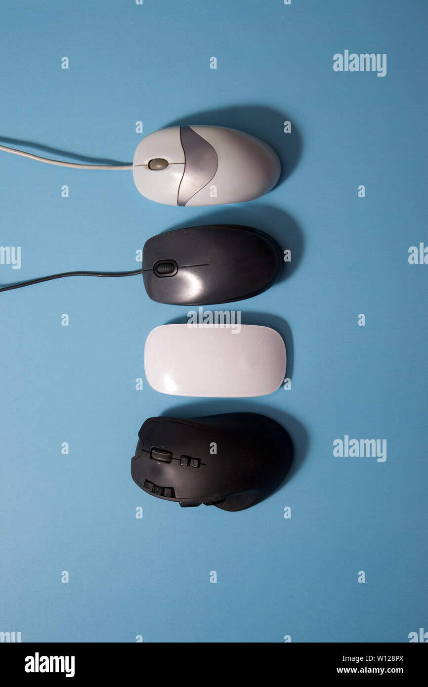 older and newer computer mouses lined up in a row Stock Photo