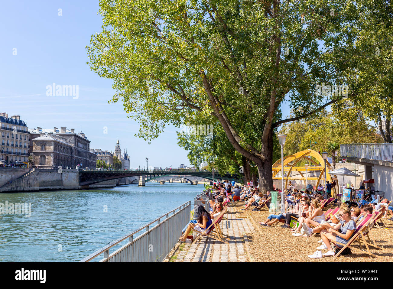 Paris, France - September 2, 2018: people from Paris enjoying a hot summer day at the Seine River margins Stock Photo