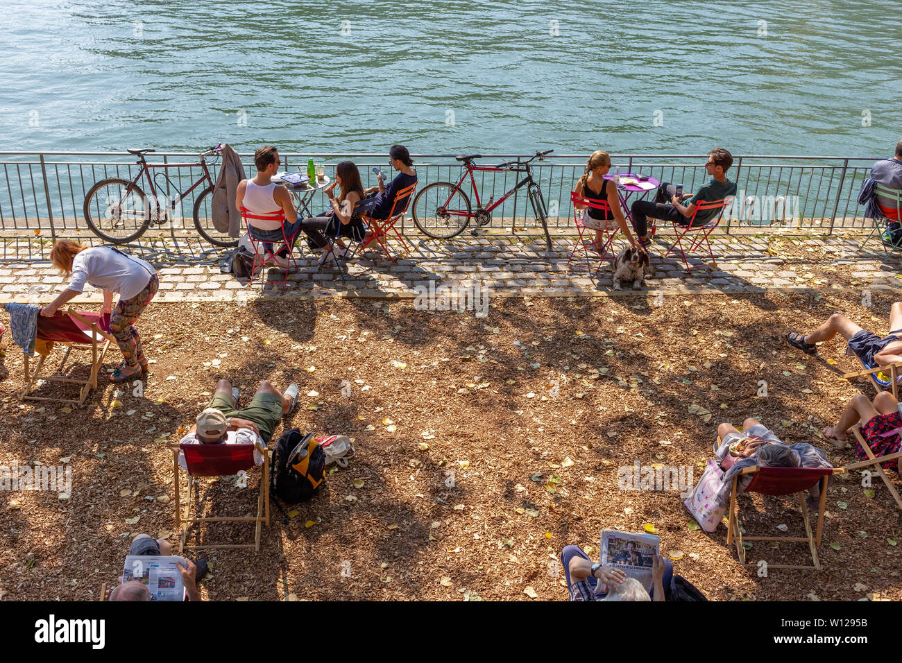 Paris, France - September 2, 2018: people from Paris enjoying a hot summer day at the Seine River margins Stock Photo