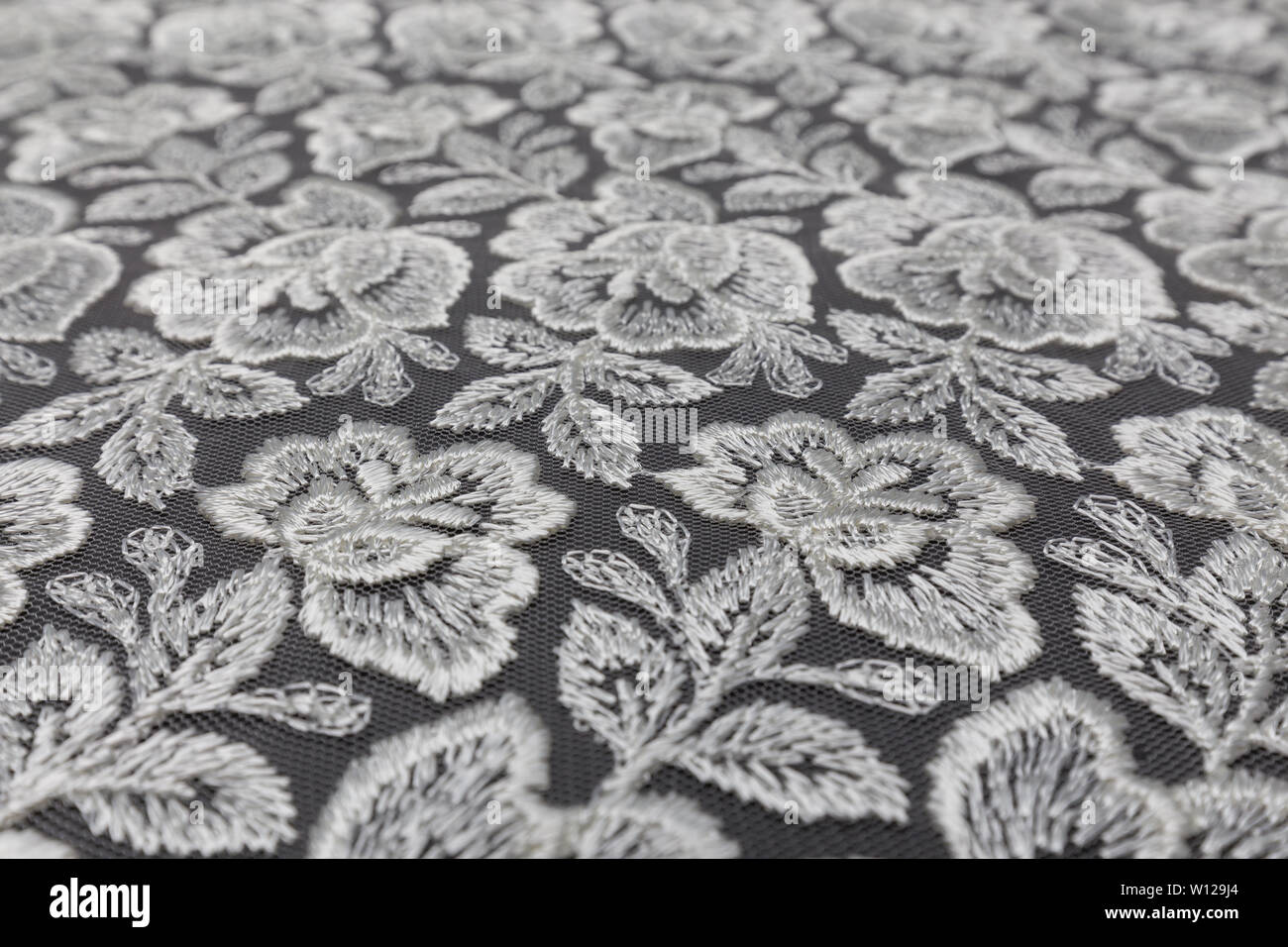 Creative black fabric with white floral pattern and textile texture background Stock Photo